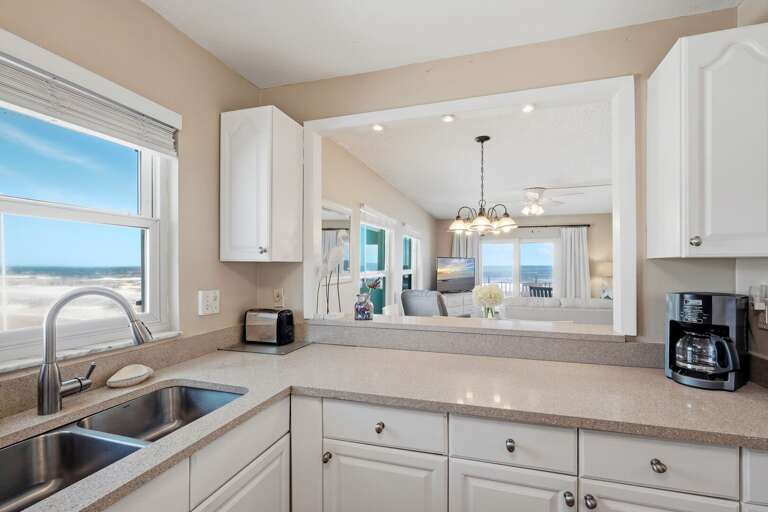 Cook with a view! This fully equipped kitchen offers stunning sights of both the sparkling pool and the serene ocean, making meal prep feel like a vacation itself Cook with a view! This fully equipped kitchen offers stunning sights of both the sparkling pool and the serene ocean, making meal prep feel like a vacation itself