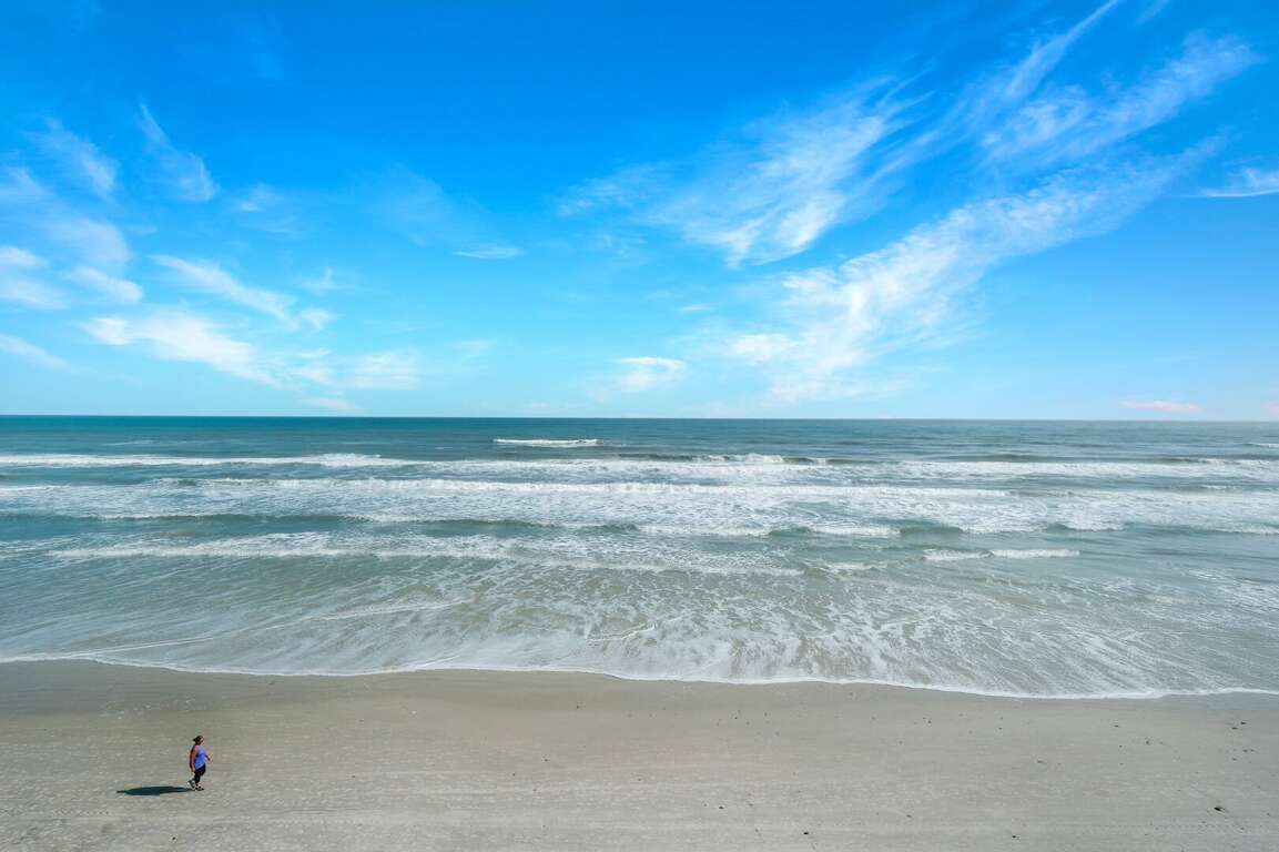 Step onto the 3rd-floor balcony and take in the panoramic views of the pristine New Smyrna Beach—your front-row seat to breathtaking sunrises and endless ocean waves Step onto the 3rd-floor balcony and take in the panoramic views of the pristine New Smyrna Beach—your front-row seat to breathtaking sunrises and endless ocean waves