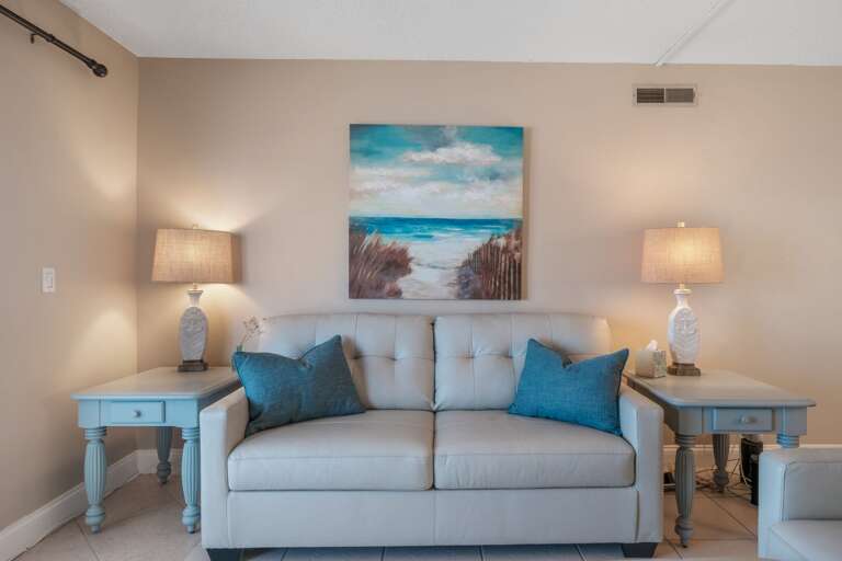 Step into the living room, where beachy blue accents create a calm, coastal vibe Step into the living room, where beachy blue accents create a calm, coastal vibe