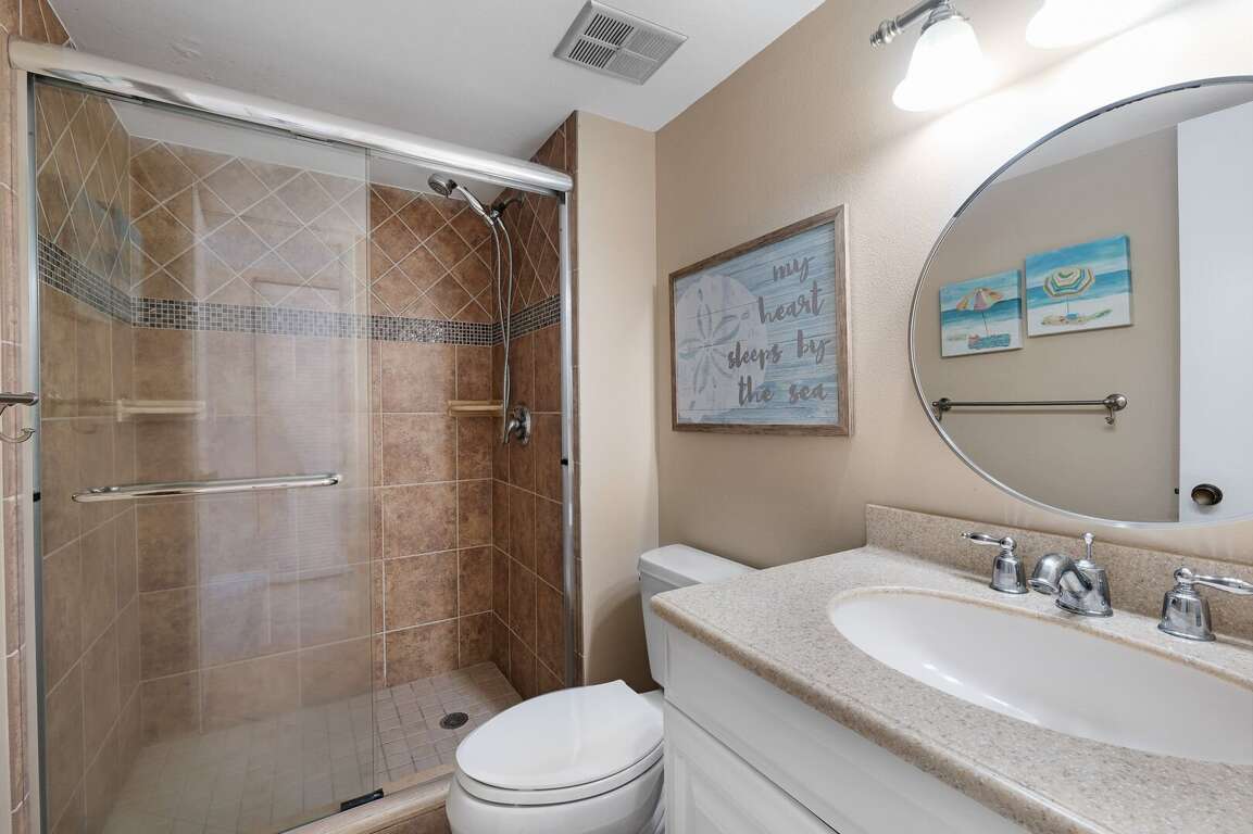Step into the updated glass and tile shower in the master bathroom, complemented by plush spa towels Step into the updated glass and tile shower in the master bathroom, complemented by plush spa towels