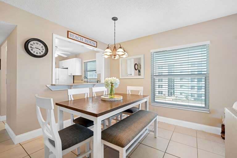 The sunny corner condo dining room offers plenty of natural light, making it the perfect spot to enjoy meals or relax and take in the views The sunny corner condo dining room offers plenty of natural light, making it the perfect spot to enjoy meals or relax and take in the views