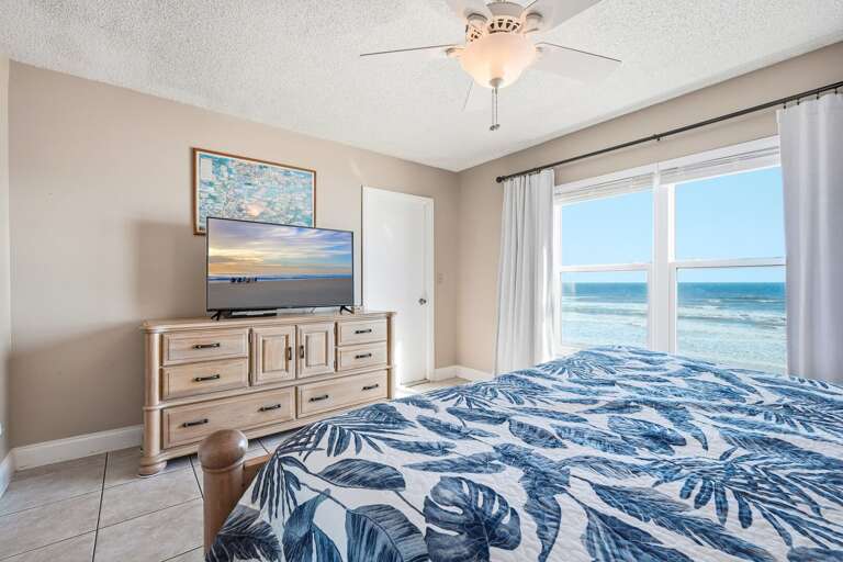 Wake up to the sound of the ocean in this direct oceanfront master bedroom, featuring a comfortable king bed and a TV Wake up to the sound of the ocean in this direct oceanfront master bedroom, featuring a comfortable king bed and a TV