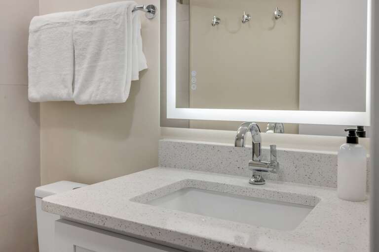 The master bathroom has been freshly updated and includes light up mirrors