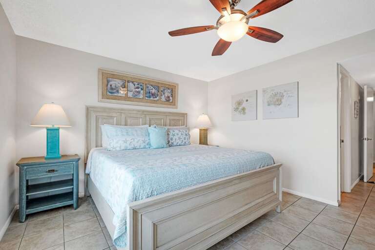 The master bedroom boasts a cozy king bed, perfect for a restful night's sleep after a day by the beach The master bedroom boasts a cozy king bed, perfect for a restful night's sleep after a day by the beach