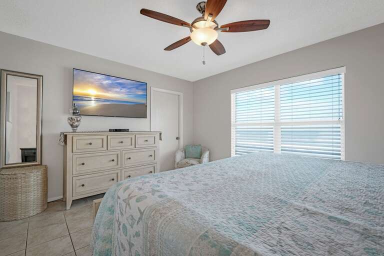 Your master bedroom retreat includes a mounted TV and an ocean view Your master bedroom retreat includes a mounted TV and an ocean view