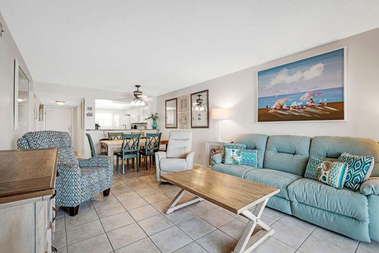 Relax in the updated living room, featuring soothing coastal blues that bring the calming ocean vibes indoors Relax in the updated living room, featuring soothing coastal blues that bring the calming ocean vibes indoors