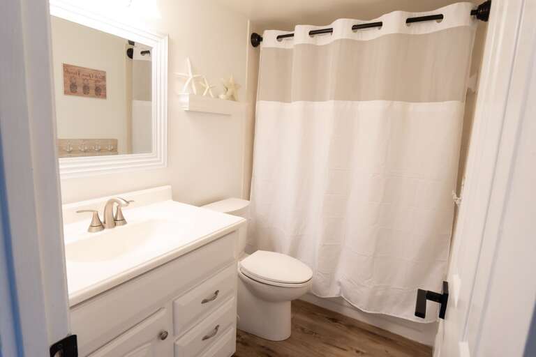 Guest Bathroom with a combo tub and shower. Guest Bathroom with a combo tub and shower.