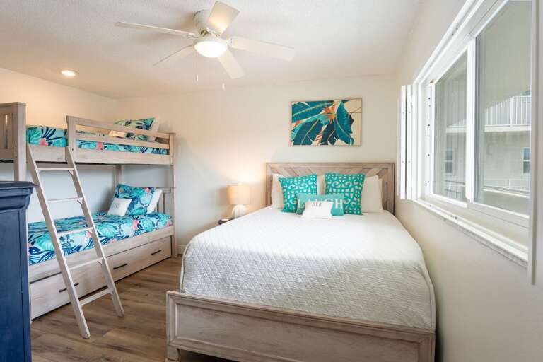 The guest room has twin bunk beds and a queen bed. The guest room has twin bunk beds and a queen bed.