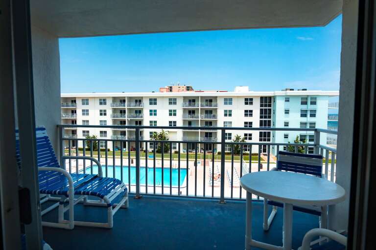 The private balcony overlooking the pools, shuffleboard, and ocean. The private balcony overlooking the pools, shuffleboard, and ocean.