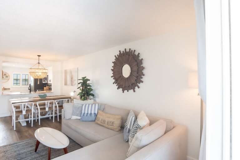 Unwind after a long day at the beach by relaxing on the living room couch. Unwind after a long day at the beach by relaxing on the living room couch.