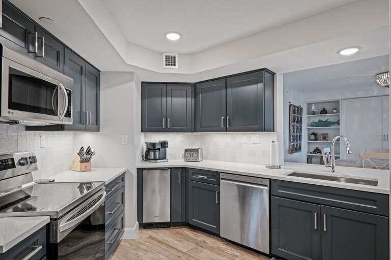 The fully equipped kitchen features sleek stainless steel appliances The fully equipped kitchen features sleek stainless steel appliances