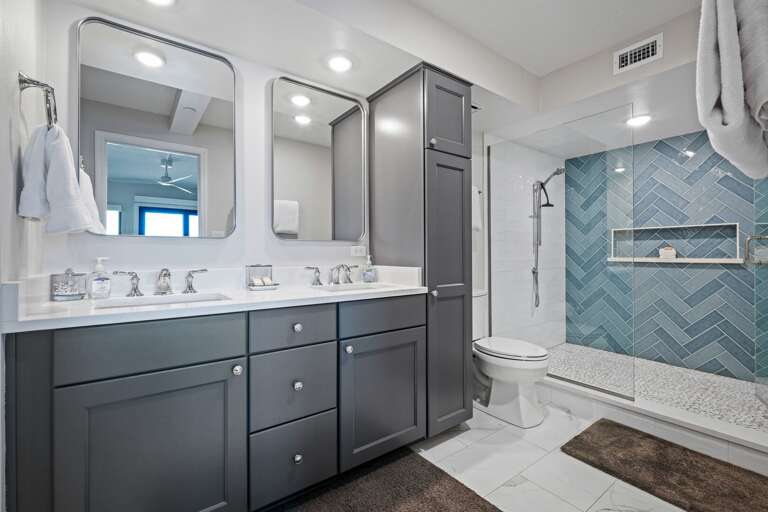 Indulge in the stunning master bathroom, complete with a double vanity, glass and tile shower, and plush spa towels Indulge in the stunning master bathroom, complete with a double vanity, glass and tile shower, and plush spa towels