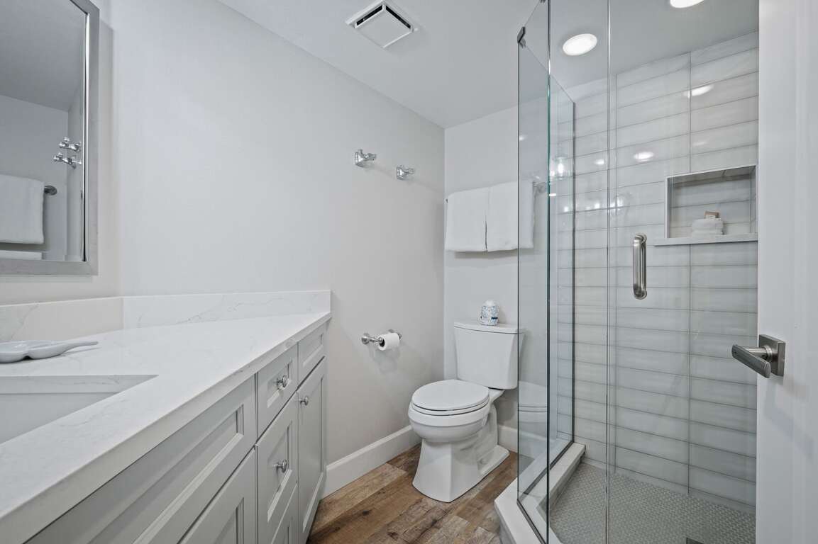 The updated guest bathroom features a sleek glass and tile shower The updated guest bathroom features a sleek glass and tile shower