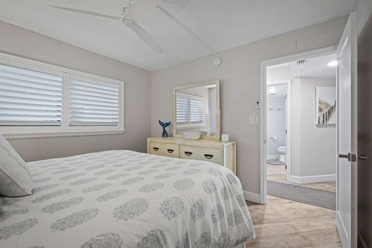 Updated guest bedroom featuring a queen bed and a dresser for ample clothing storage Updated guest bedroom featuring a queen bed and a dresser for ample clothing storage