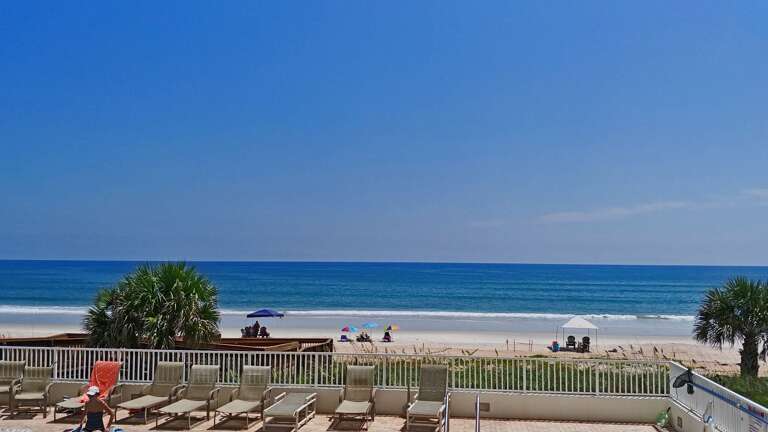Take in stunning Ormond Beach views while lounging poolside at Seawinds' scenic deck