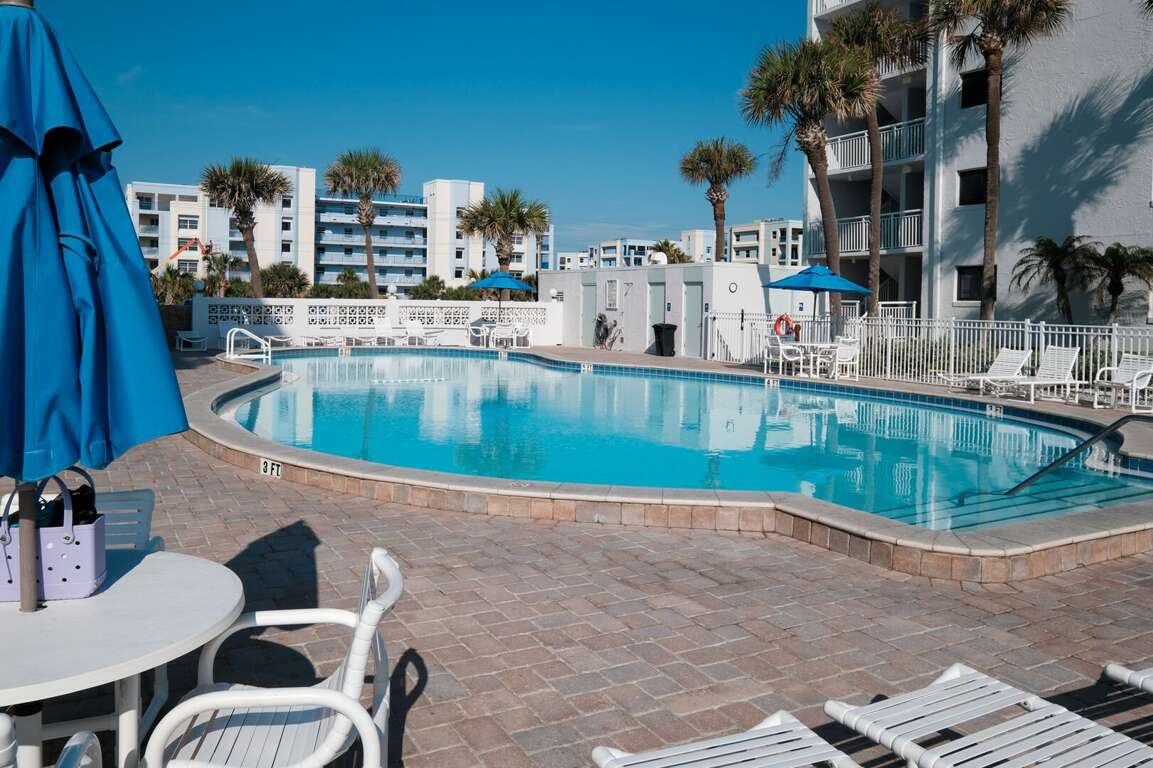 Enjoy the convenience of tables, chairs, and poolside bathrooms on Shorehom by the Sea's pool deck Enjoy the convenience of tables, chairs, and poolside bathrooms on Shorehom by the Sea's pool deck