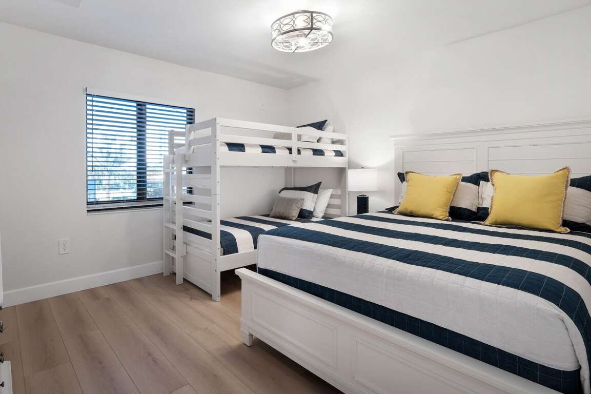 The guest bedroom sleeps up to 4 guests with a queen bed and a twin bunk bed The guest bedroom sleeps up to 4 guests with a queen bed and a twin bunk bed