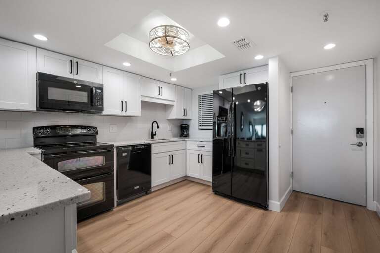 The kitchen features stylish black appliances and modern finishes The kitchen features stylish black appliances and modern finishes