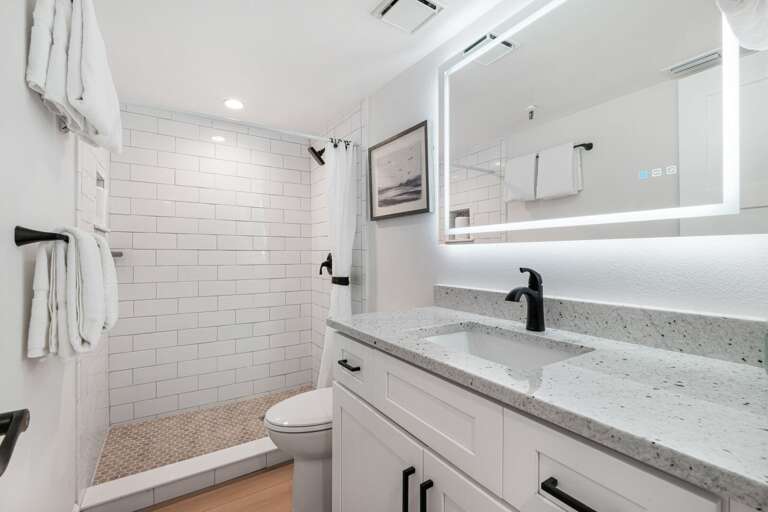 The updated guest bathroom has a tile shower and plush spa towels The updated guest bathroom has a tile shower and plush spa towels
