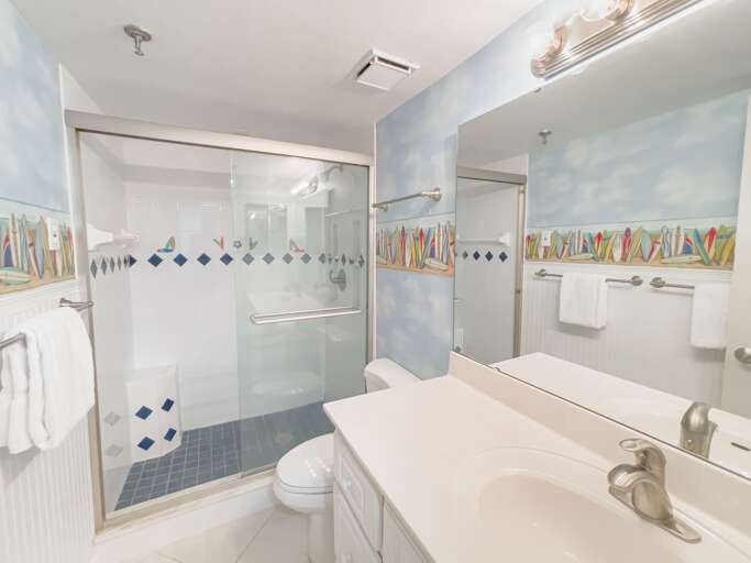 The guest bathroom features a glass and tile shower, offering a clean and refreshing space The guest bathroom features a glass and tile shower, offering a clean and refreshing space
