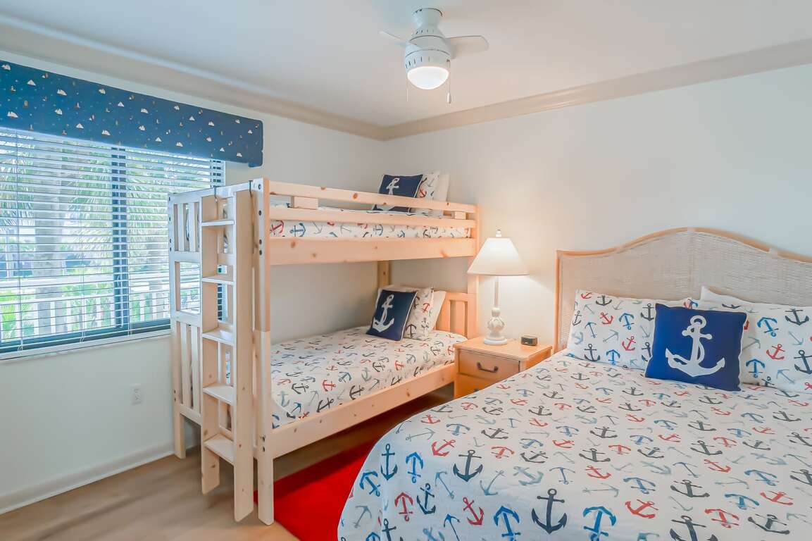 The guest bedroom comfortably sleeps four with a queen bed and a twin bunk bed, perfect for families or groups The guest bedroom comfortably sleeps four with a queen bed and a twin bunk bed, perfect for families or groups