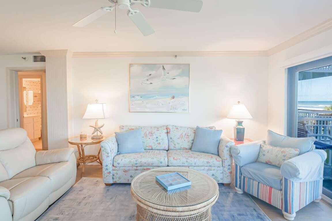 The living area offers comfortable seating, providing a relaxing space to unwind after a day at the beach The living area offers comfortable seating, providing a relaxing space to unwind after a day at the beach