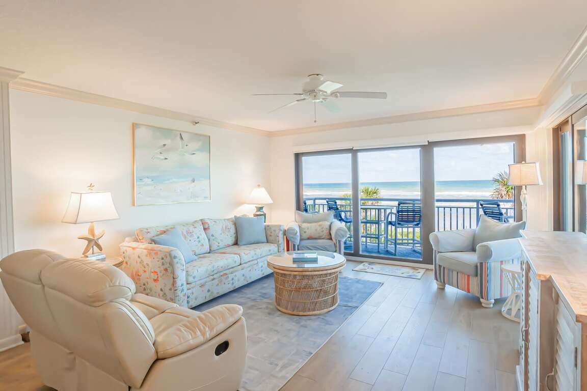 The oceanfront living room offers plenty of comfortable seating, including a recliner, with stunning beach views The oceanfront living room offers plenty of comfortable seating, including a recliner, with stunning beach views