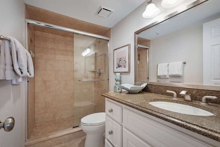 Guest bathroom with a glass and tile shower