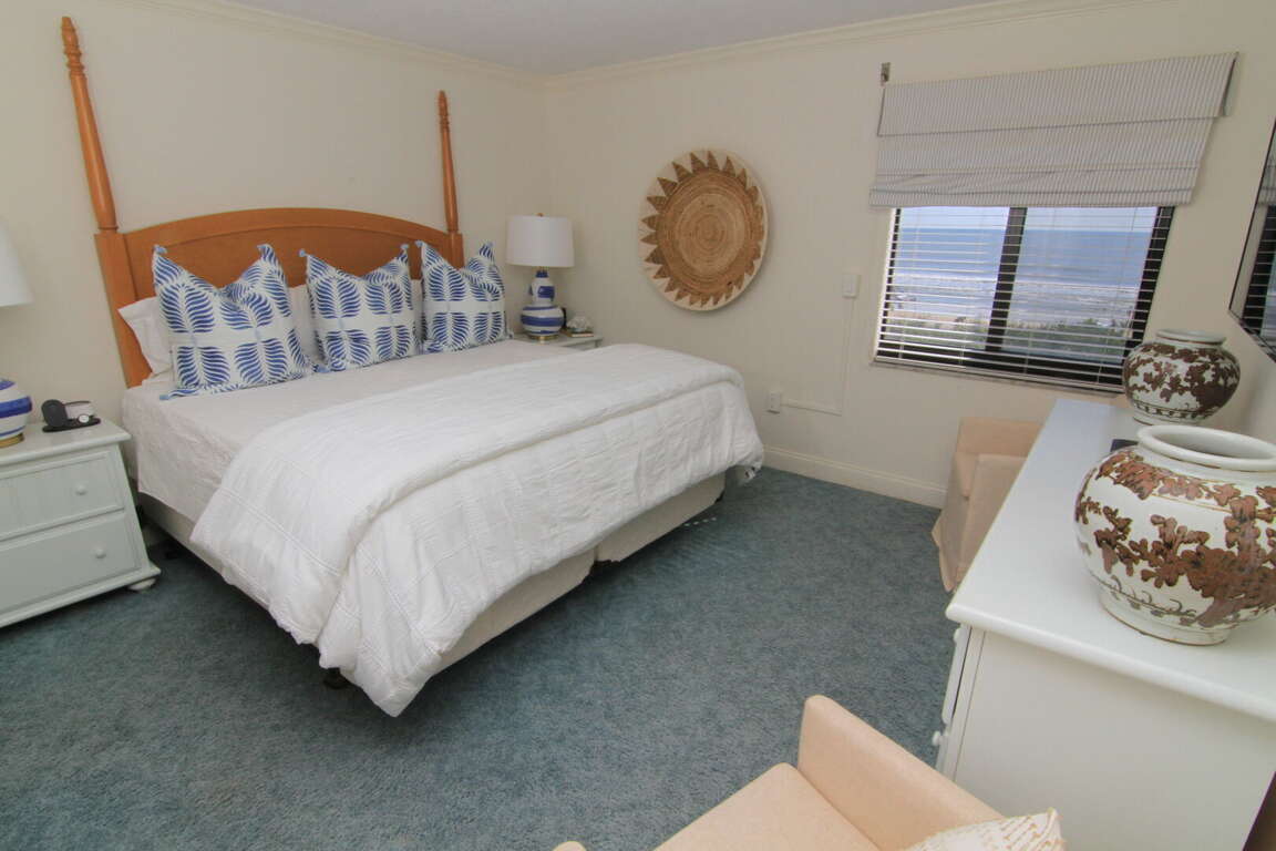 Updated master bedroom with a beach view Updated master bedroom with a beach view