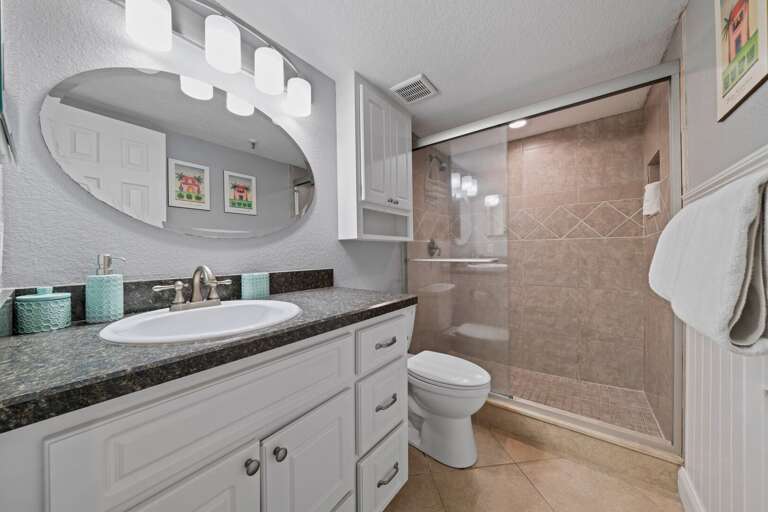 Ensuite master bathroom with an updated glass and tile shower