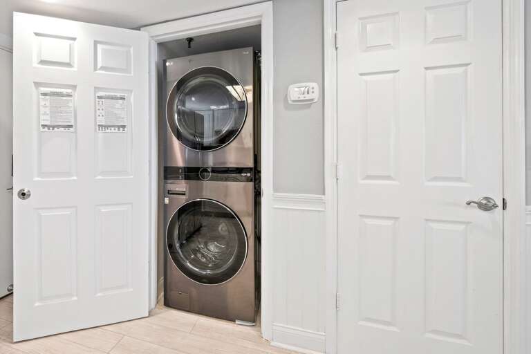 A full-sized washer and dryer are conventionality located inside the condo
