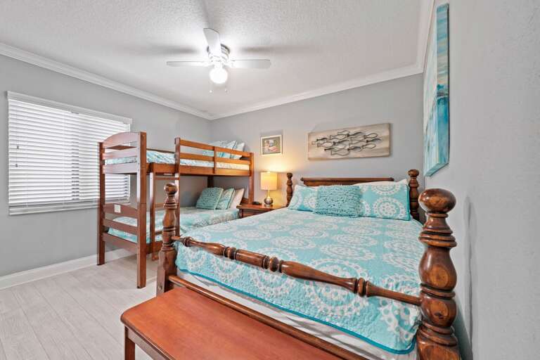 The guest bedroom accommodates 4 with a queen bed and a twin bunk bed