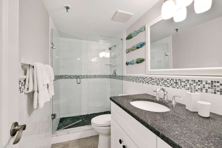 The guest bathroom has an updated glass and tile shower The guest bathroom has an updated glass and tile shower