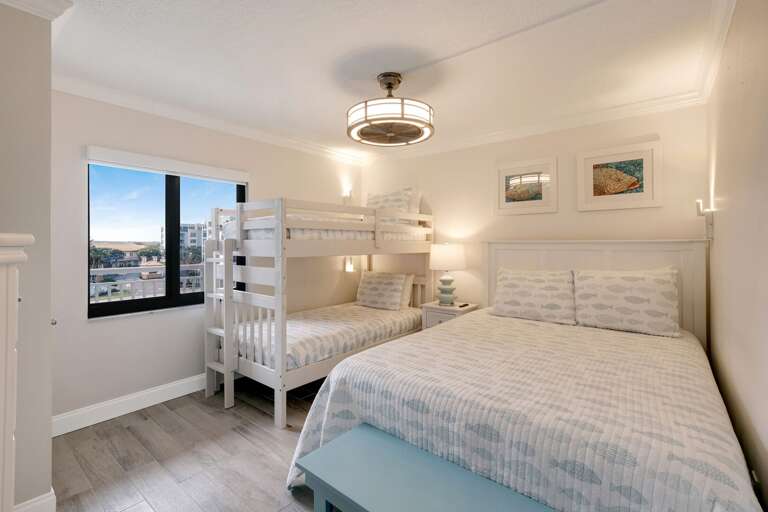 The guest bedroom sleeps 4 with a queen bed and a twin bunk bed The guest bedroom sleeps 4 with a queen bed and a twin bunk bed