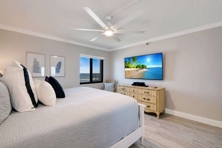 The master bedroom features a King Bed, large TV, and a beautiful view of New Smyrna Beach The master bedroom features a King Bed, large TV, and a beautiful view of New Smyrna Beach