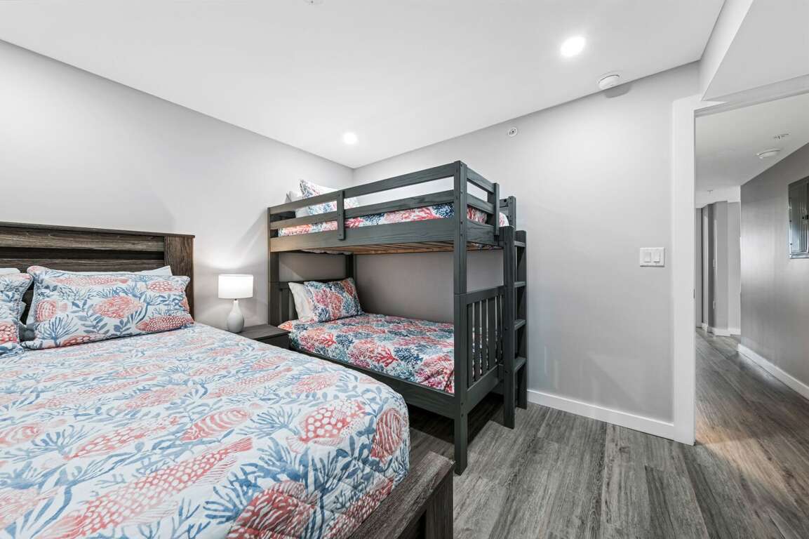 The guest bedroom sleeps 4 with a queen bed and a twin bunk bed The guest bedroom sleeps 4 with a queen bed and a twin bunk bed