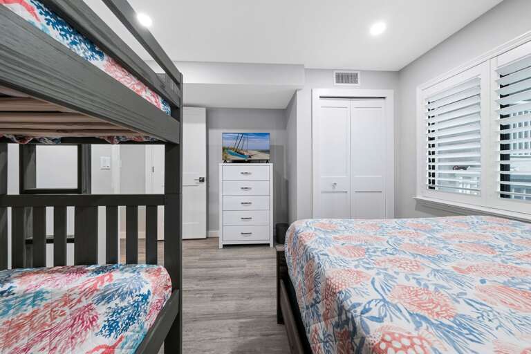 The guest bedroom has a TV and closet for storage The guest bedroom has a TV and closet for storage