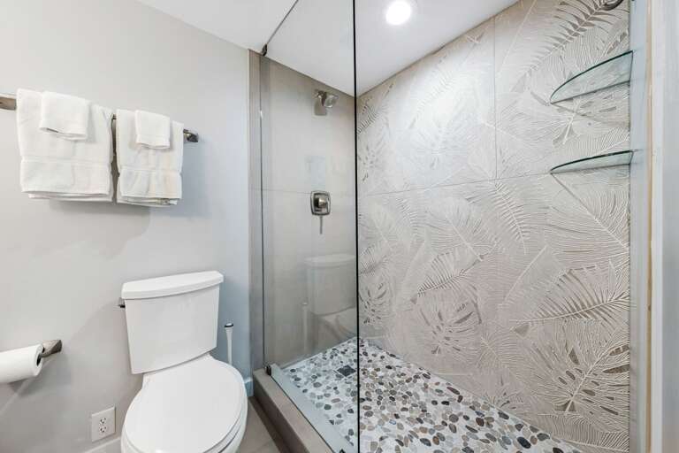 Tile and glass shower and plush spa towels in the master bathroom Tile and glass shower and plush spa towels in the master bathroom