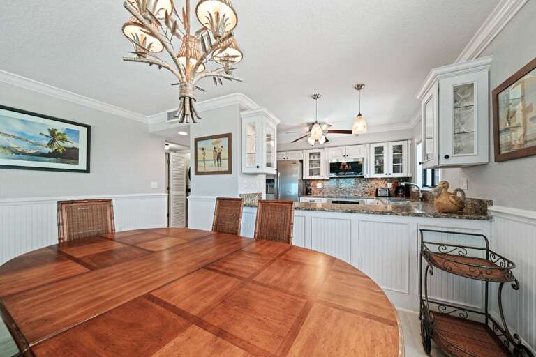Dining room with seating for six and beautiful views of the beach and pool