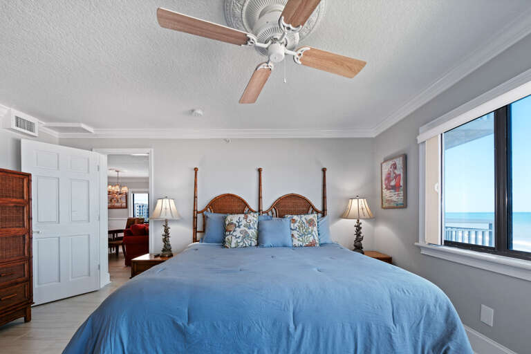 Master bedroom featuring a king bed and stunning views of the no-drive New Smyrna Beach