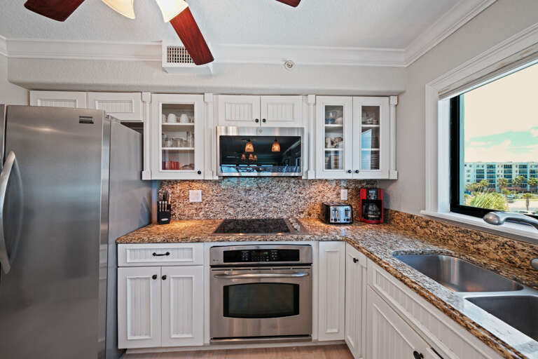 Updated kitchen with a window over the sink offering a lovely view of the pool