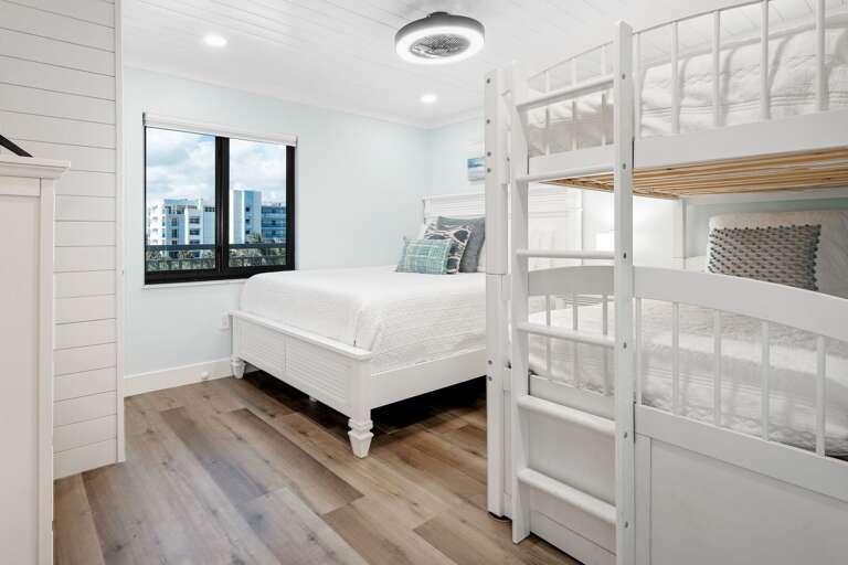 Guest bedroom with a queen bed and twin bunk bed