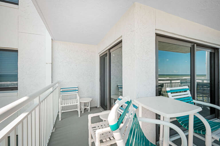 Large balcony with ample seating, including chairs and tables for dining or relaxing