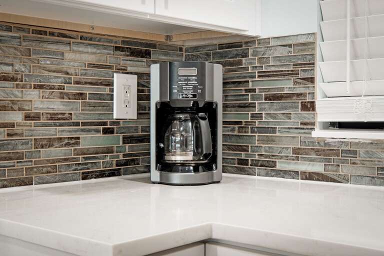 A standard drip coffee maker is provided in the updated kitchen
