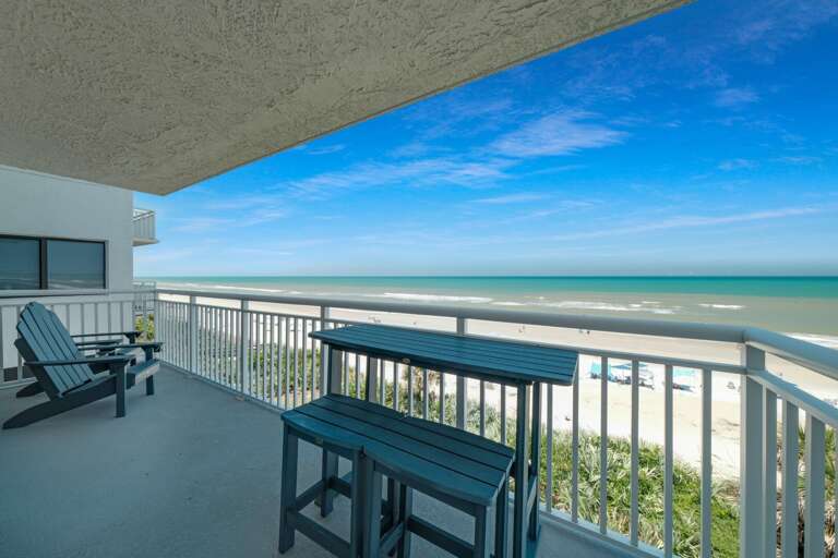 The balcony furniture is perfect for relaxing while taking in the beachfront views