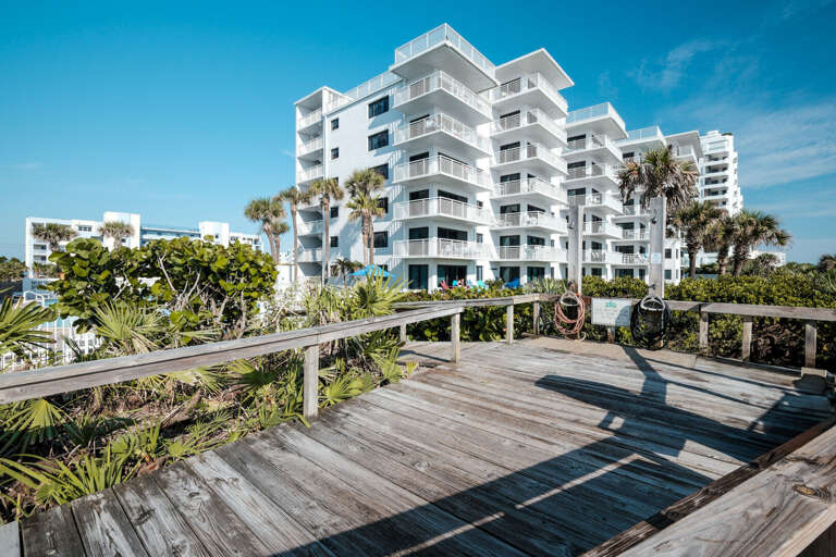 Shorehom by the Sea has a private beach access boardwalk with a sand rinse area