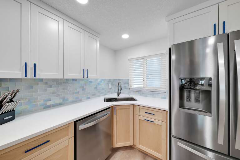 Stainless steel refrigerator and dishwasher in the kitchen
