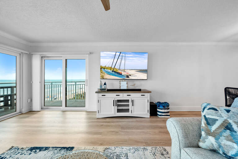 Watch the smart TV in the spacious living room with an ocean view