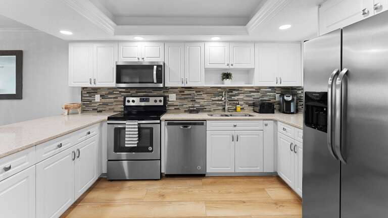 Modern and updated, the kitchen features sleek stainless steel appliances, making it the perfect space for preparing meals during your stay