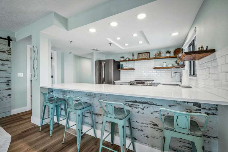 4 barstools provide additional seating at the kitchen counter